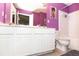 Bright bathroom featuring double sink vanity, white cabinets and tile, and stylish modern finishes at 9155 Nesbit Ferry Rd, Alpharetta, GA 30022