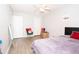 Cozy bedroom featuring wood-look floors, a minimalist bed, and a bright, airy atmosphere at 9155 Nesbit Ferry Rd, Alpharetta, GA 30022