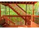 View of the property's deck with painted wood and surrounding lush green landscape creating an inviting outdoor space at 9155 Nesbit Ferry Rd, Alpharetta, GA 30022