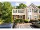 Charming townhome featuring manicured landscaping and assigned parking spaces at 9155 Nesbit Ferry Rd, Alpharetta, GA 30022