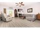 Spacious living room with modern flooring and a sliding glass door leading to a deck at 9155 Nesbit Ferry Rd, Alpharetta, GA 30022