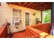 A porch with a painted wood deck, exterior lighting, tan siding and view of surrounding landscape at 9155 Nesbit Ferry Rd, Alpharetta, GA 30022