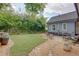 Lush backyard featuring a stone walkway, manicured lawn, and patio area perfect for outdoor gatherings at 1143 Church Nw St, Atlanta, GA 30318