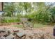 Landscaped backyard featuring a stone patio, lush greenery, and a seating area ideal for outdoor enjoyment at 1143 Church Nw St, Atlanta, GA 30318