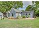 Beautifully landscaped backyard with lush green grass, garden beds, and mature trees create a serene outdoor space at 1143 Church Nw St, Atlanta, GA 30318