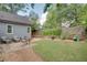 Beautifully landscaped backyard with a well-manicured lawn, stone accents, and a private outdoor seating area at 1143 Church Nw St, Atlanta, GA 30318