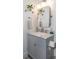 Bright bathroom with stylish gray vanity, shelving, mirror, marble countertop, and modern fixtures at 1143 Church Nw St, Atlanta, GA 30318