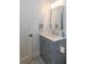 Bathroom showcasing a gray vanity with drawers, countertop, mirror, and modern fixtures at 1143 Church Nw St, Atlanta, GA 30318