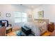 Inviting bedroom with a cushioned bed, window, chair, and hardwood floors at 1143 Church Nw St, Atlanta, GA 30318