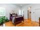 Bright bedroom featuring wood floors, white walls, and a cozy bed with purple bedding at 1143 Church Nw St, Atlanta, GA 30318