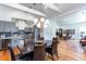 Open-concept dining room with stylish lighting fixture and view of the modern kitchen at 1143 Church Nw St, Atlanta, GA 30318