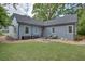 Rear exterior view showing a well-maintained home with a spacious yard and outdoor entertaining space at 1143 Church Nw St, Atlanta, GA 30318