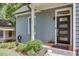 Inviting front porch with a modern door, manicured bushes and clear house number create a welcoming entrance at 1143 Church Nw St, Atlanta, GA 30318