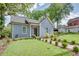 Charming single-Gathering home with a well-manicured front yard, mature trees, and inviting curb appeal at 1143 Church Nw St, Atlanta, GA 30318