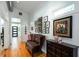 Inviting hallway with wood floors, a bench, and wall art leading to the front door at 1143 Church Nw St, Atlanta, GA 30318