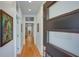Bright hallway with hardwood floors, white walls, and a front door with modern glass panes, creating an open, airy feel at 1143 Church Nw St, Atlanta, GA 30318