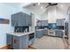 Stylish kitchen featuring grey cabinetry, stainless steel appliances, and patterned floors at 1143 Church Nw St, Atlanta, GA 30318