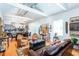 Open-concept living room featuring exposed duct work, hardwood floors, ample seating, and an open view into the kitchen at 1143 Church Nw St, Atlanta, GA 30318