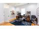 Well-lit office with hardwood floors, featuring a modern adjustable desk, office chair, and functional shelving at 1143 Church Nw St, Atlanta, GA 30318