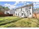 View of the home's backyard with a large lawn, patio, and wood fence at 1511 Arica Ave, Lawrenceville, GA 30043