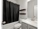Neutral full bathroom featuring tile flooring, shower-tub, and wood shelves at 1511 Arica Ave, Lawrenceville, GA 30043