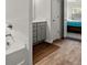 This bathroom has wood flooring and a gray vanity at 1511 Arica Ave, Lawrenceville, GA 30043