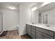 This bathroom features a double sink vanity with a neutral color palette at 1511 Arica Ave, Lawrenceville, GA 30043