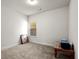 Clean, carpeted bedroom featuring a window with blinds and neutral paint at 1511 Arica Ave, Lawrenceville, GA 30043