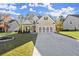 Attractive home with well-kept lawn, modern gray garage door and brick accents at 1511 Arica Ave, Lawrenceville, GA 30043