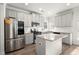 Modern kitchen boasts gray cabinets, granite countertops, stainless steel appliances, and a central island at 1511 Arica Ave, Lawrenceville, GA 30043