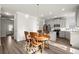 Bright kitchen with a wooden dining table set, gray cabinets, stainless steel appliances, and granite countertops at 1511 Arica Ave, Lawrenceville, GA 30043