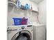 Laundry room featuring a front load washer and dryer, storage shelf, and laundry basket at 1511 Arica Ave, Lawrenceville, GA 30043