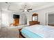 The main bedroom boasts a ceiling fan, a TV, and wooden furniture at 1511 Arica Ave, Lawrenceville, GA 30043
