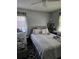 Cozy bedroom with a neutral palette, featuring a comfortable bed, soft lighting, and a ceiling fan at 1990 Shamrock Dr, Decatur, GA 30032