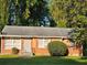 Charming single-story brick home featuring a well-maintained lawn and mature trees at 1990 Shamrock Dr, Decatur, GA 30032