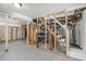 Unfinished basement with stairs, exposed pipes, and concrete floor, ready to be finished at 3204 Robin Rd, Decatur, GA 30032