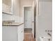 Bathroom featuring granite countertop sink and bathtub with white tile surround at 3204 Robin Rd, Decatur, GA 30032