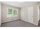 Cozy bedroom featuring carpet, wood-paneled walls, and ample natural light at 3204 Robin Rd, Decatur, GA 30032