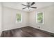 Bright bedroom features hardwood floors, ceiling fan, and natural light from two windows at 3204 Robin Rd, Decatur, GA 30032