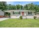 Charming single-story home featuring a cozy carport and a well-maintained front yard at 3204 Robin Rd, Decatur, GA 30032