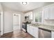 Bright kitchen featuring updated appliances, granite countertops, and ample cabinet space at 3204 Robin Rd, Decatur, GA 30032