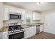 Modern kitchen featuring stainless steel appliances, white cabinets, and granite countertops at 3204 Robin Rd, Decatur, GA 30032