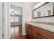Bathroom with granite counters and wood cabinets, leading to the bedroom at 1538 Chantilly Ne Dr # 224, Atlanta, GA 30324