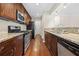 Galley kitchen featuring stainless steel appliances, granite countertops, and wood cabinets at 1538 Chantilly Ne Dr # 224, Atlanta, GA 30324