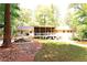 Backyard with screened porch and mature trees, perfect for enjoying nature at 3320 Bryant Ln, Marietta, GA 30066