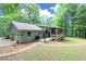 Exterior view of a charming home with a screened porch, lush lawn, and attached garage at 3320 Bryant Ln, Marietta, GA 30066