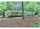 Charming home with stone accents, covered porch, and lush landscaping in a wooded setting at 3320 Bryant Ln, Marietta, GA 30066