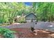 Home's exterior with a two-car garage, long driveway and view of the surrounding woods at 3320 Bryant Ln, Marietta, GA 30066