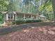 Charming exterior featuring a welcoming front porch with stone accents and lush greenery at 3320 Bryant Ln, Marietta, GA 30066