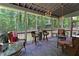 Relaxing screened porch with comfortable seating, chandelier and views of the wooded backyard at 3320 Bryant Ln, Marietta, GA 30066